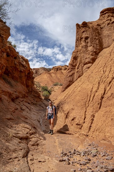 Climber in a canyon with a dry stream bed