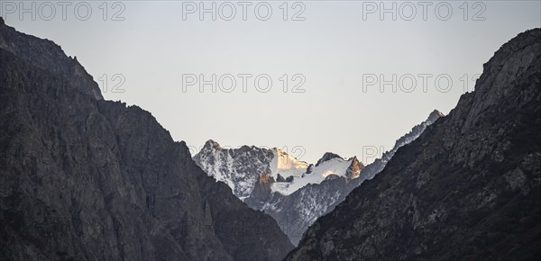 Glaciated mountain peak at sunset