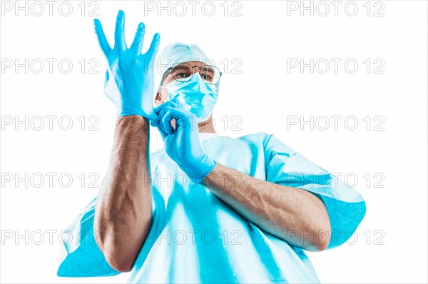 Portrait of a doctor on a white background. He pulls on the glove. Medicine concept.