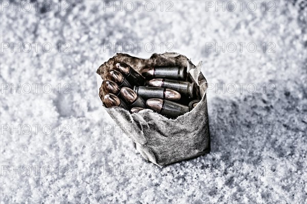 Package of ammunition is thrown into the snow.