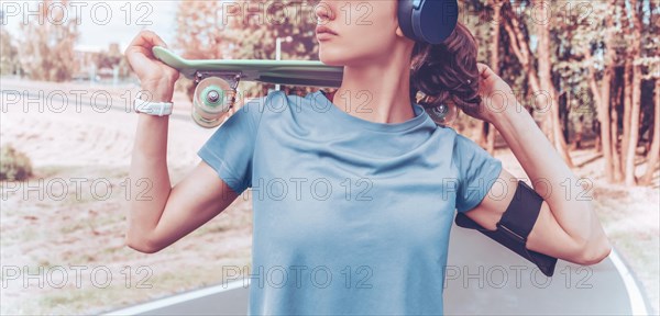 No name portrait of a girl with a skateboard. Sports lifestyle concept.