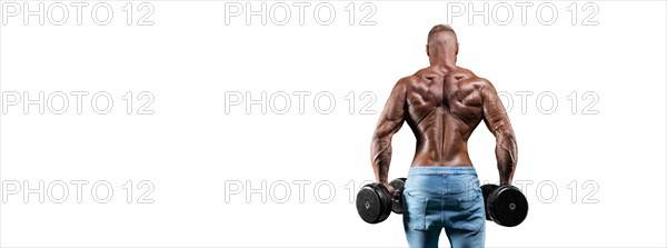 The athlete performs an exercise with dumbbells on a white background. Back view. Shrugs. Fitness