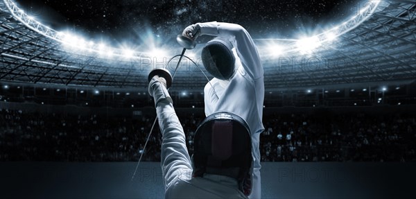 Portrait of two fencers against the backdrop of a sports arena. The concept of fencing. Duel.