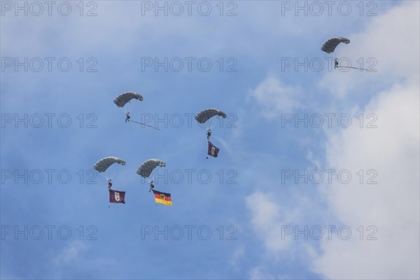 Bundeswehr parachutist with German flag. Spotterday for the Day of the German Armed Forces at Bueckeburg Army Airfield