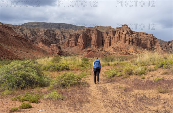 Climber in a canyon with a dry stream bed