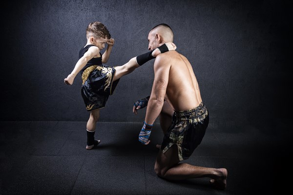 Kickboxing coach is training the boy. The concept of family