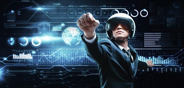 Portrait of a man in a suit and helmet. He shows that he is flying against the background of a hologram of market trading. Business concept. Stock market. Brokers and traders.