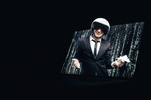 Portrait of a man in a suit and helmet. He launches a paper airplane from a laptop screen. Web Design Concept.