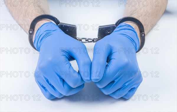 Hands of a doctor in handcuffs. The concept of corruption in medicine.