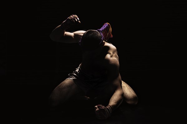 Thai boxer punches on the floor of the ring. Mongkhon. The concept of tournaments