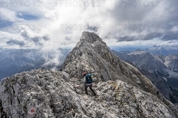 Mountaineer on a narrow rocky ridge