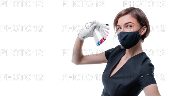 Portrait of an elegant beautiful girl with a set of nail palette in hand. The concept of beauty salons