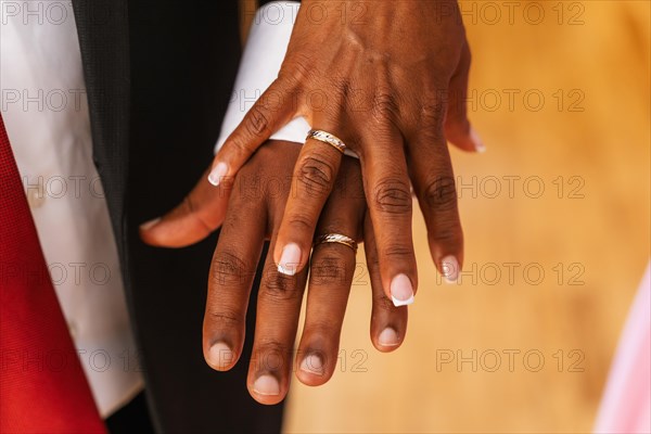 Black ethnic couple embracing with ring at a beautiful wedding