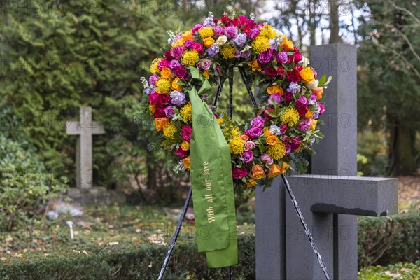 Funeral wreath with flowers at a grave