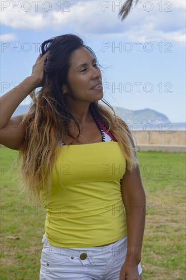 Beautiful and happy latin woman with long hair smiling
