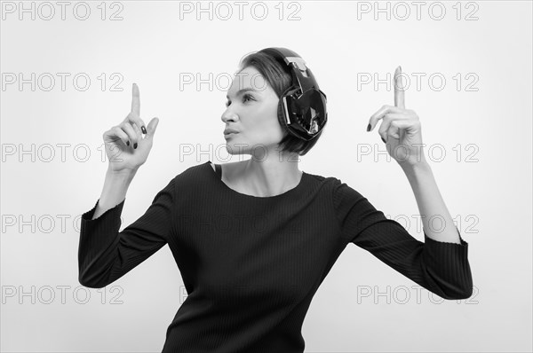 Portrait of a woman in professional headphones. White background. Dj concept.