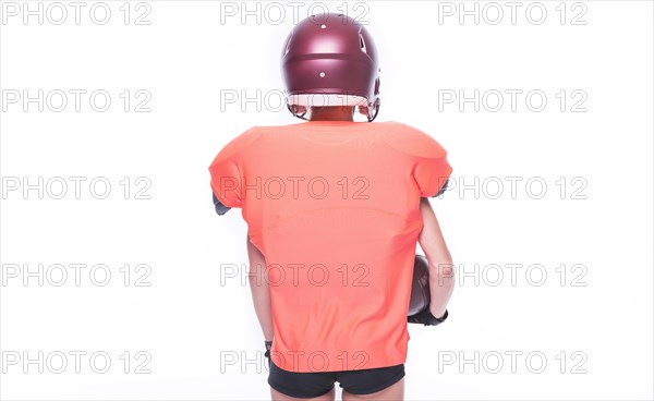 Woman in the uniform of an American football team player posing in the studio. White background. Back view. Sports concept.