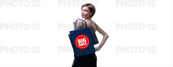 Beautiful young woman in white gloves threw a black craft bag over her shoulder. Shopaholics concept. Spenting. Gifts for the holidays. Black Friday. Shopping centers