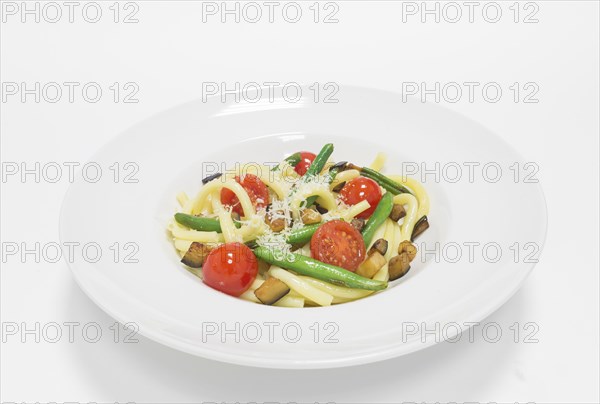 Gourmet pasta with basil and mozzarella balls. Top view. White background. Healthy eating concept.