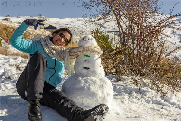 Snowy Escapades Happy Latina Woman Making Memories with Snowman