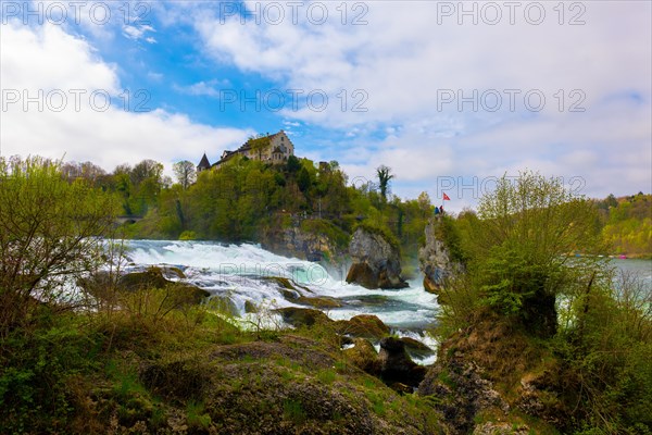 Rhine Falls and Swiss Flag with the Castle Laufen at Neuhausen in Schaffhausen