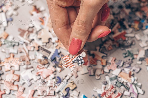 Woman holds puzzle with usa flag. Economic and political concept.