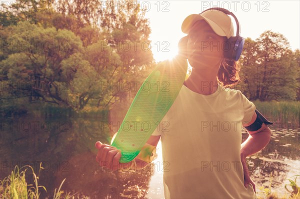 Portrait of a teenage girl with a skateboard. Sports lifestyle concept.