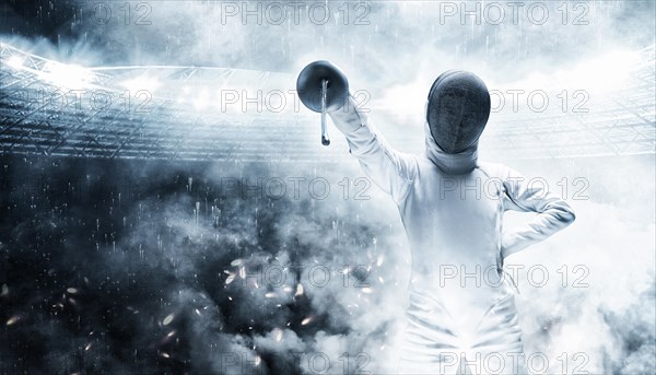 Portrait of a fencer against the backdrop of a sports arena. Smoke and sparks