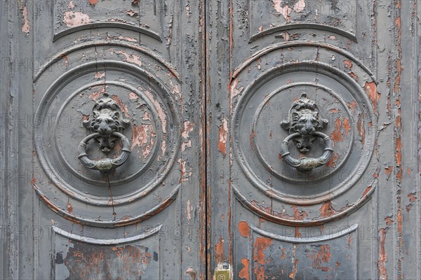 Door knocker at an old entrance gate in the historic centre