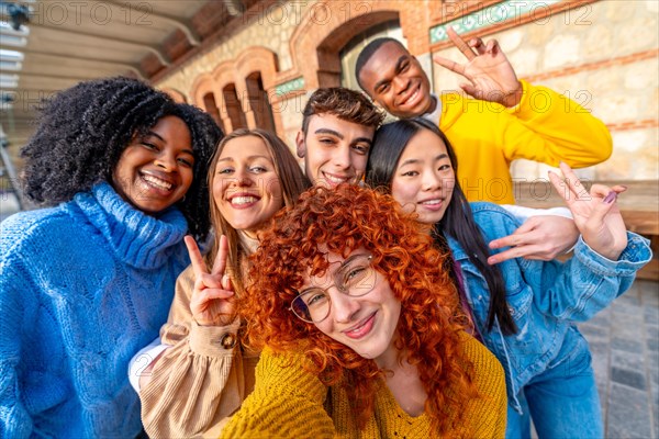 Students gesturing success while taking a selfie in the city