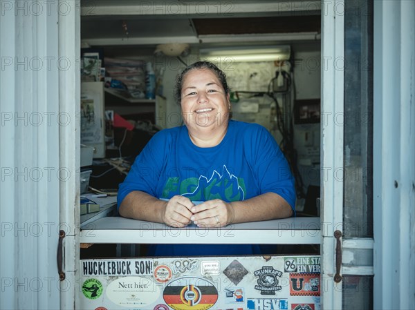 Employee at the counter of the Ochopee Post Office