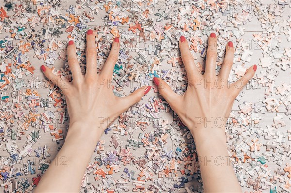 Woman arranges puzzles. Board game concept. Stay at home.