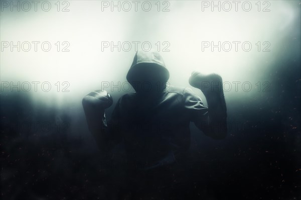 Fighter without a face is standing with his hands up. The concept of boxing