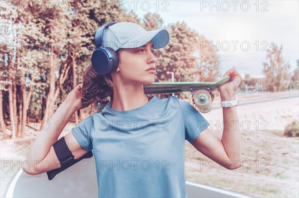 Portrait of a teenage girl with a skateboard. Sports lifestyle concept.