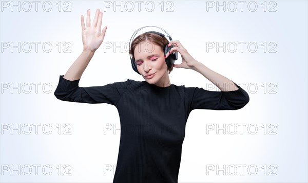 Portrait of a woman in professional headphones. White background. Dj concept.