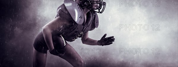 Image of a girl in the uniform of an American football team player. She runs with the ball against the background of light spots. Sports concept. Shoulders pads.