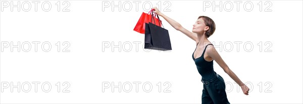 Portrait of a beautiful woman with packages. She enthusiastically rushes shopping. Shopaholic concept. Shopping centers. Sales.