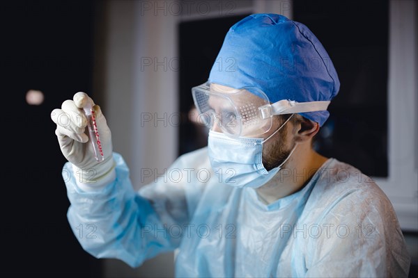 Scientist doctor in the laboratory examines the samples of the virus in vitro. vaccine development concept