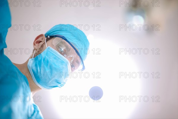 Male surgeon doctor in the operating room looking at the patient