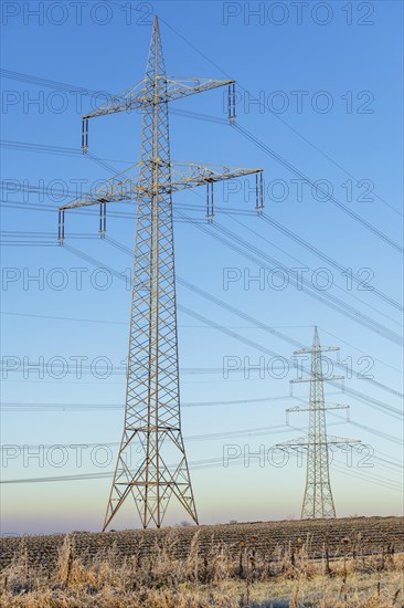 High-voltage pylons in a field