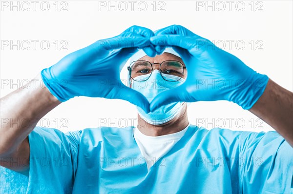 Portrait of a doctor on a white background. He folded his hands in the shape of a heart. Medicine concept.