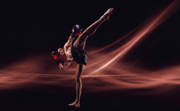 The mma fighter hits a high kick. Kickboxing concept. High quality