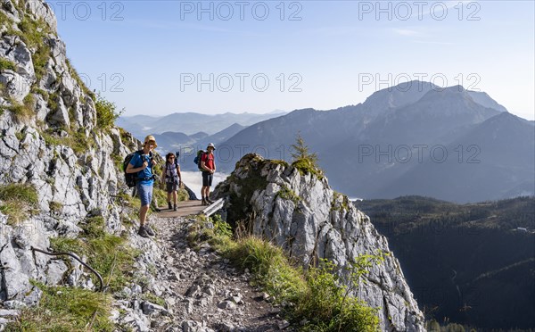 Three mountaineers on a hiking trail
