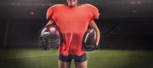 Iimage of a girl at the stadium in the uniform of an American football team player. Sports concept.