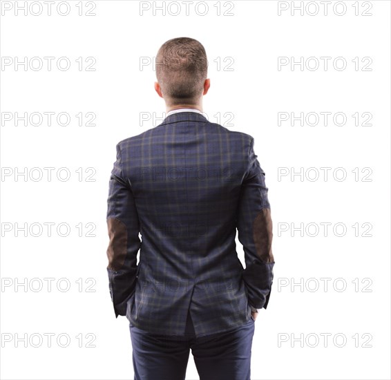 Man stands with his back to the camera and looking at something