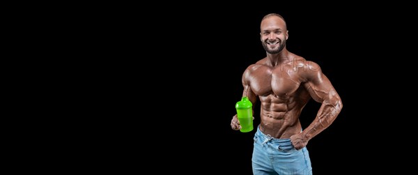 Isolated muscular man on a black background. Bodybuilding and fitness concept. Panorama.