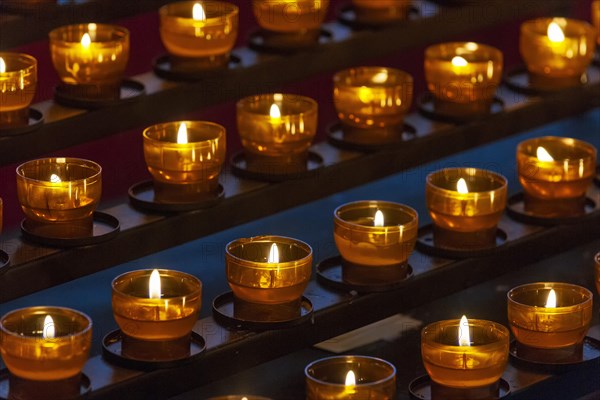 Burning sacrificial candles in a church