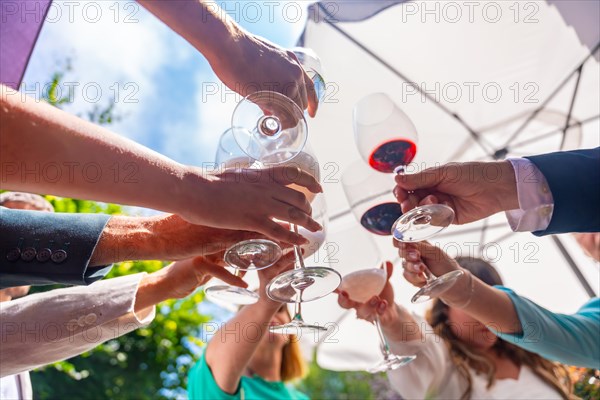 Hands of friends in a toast of friends at an event or at a wedding
