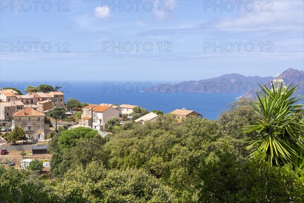 The Corsican village of Piana with the rocky coast of the Gulf of Porto in the background