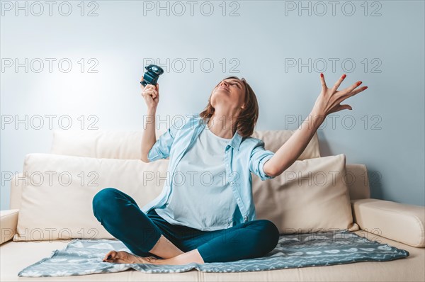 Girl with a joystick in her hands rejoices in victory. ESports concept.